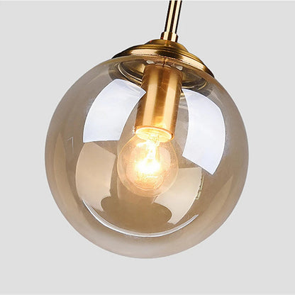 Lámpara colgante Orbelle Art Déco de latón con globo de cristal